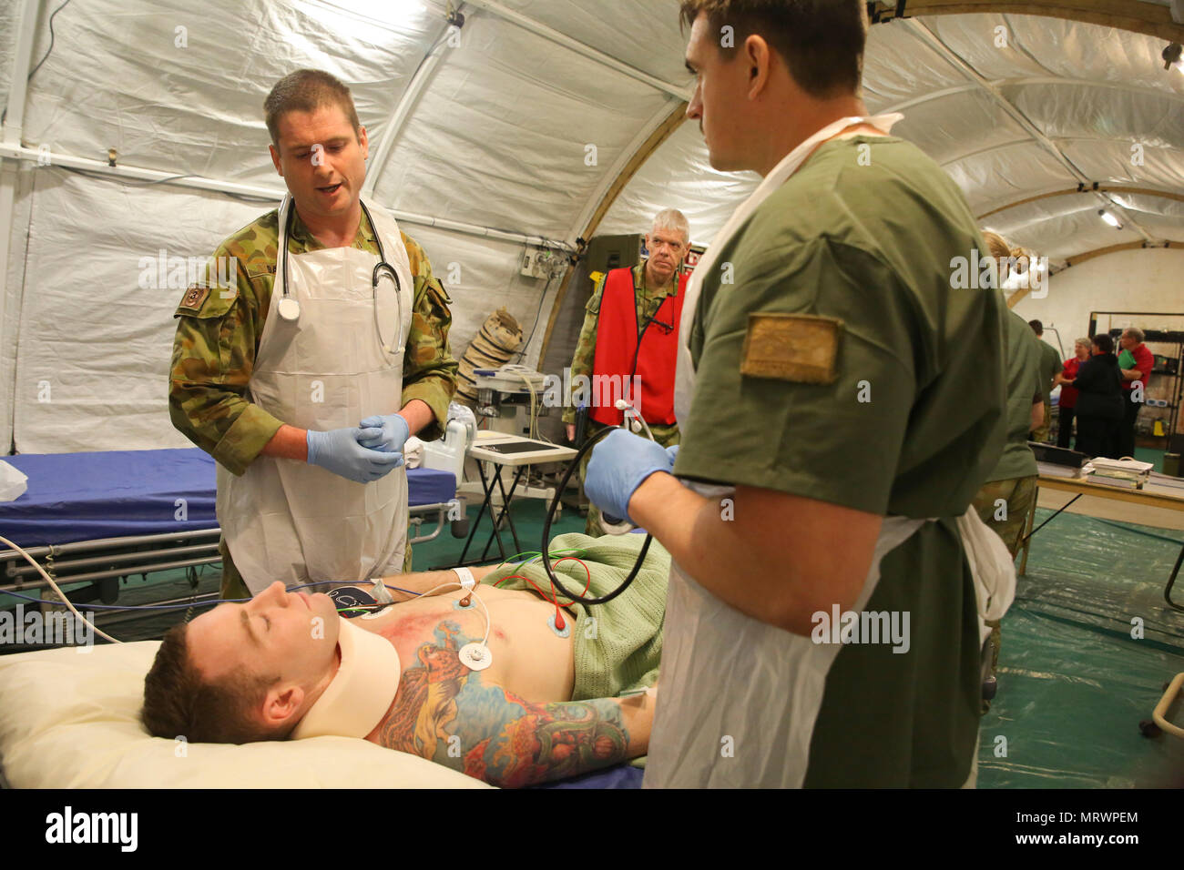 Major Paddy Bates, a trauma nurse with 3rd Health Support Battalion, 17th Combat Service Support Brigade, and Corporal James Gummow, a medic with 2nd General Health Battalion, 17th CSS Brigade, evaluate a patient with a simulated sternum fracture during a mass casualty exercise at Williamson Air Field, Shoalwater Bay Training Area, Queensland, Australia, July 8, 2017 during Talisman Saber 17. Australian Army soldiers with 17th CSS Brigade conducted a mass-casualty exercise at Williamson Air Field hospital to practice Role 2 advanced trauma care and procedures that are used in a deployed enviro Stock Photo