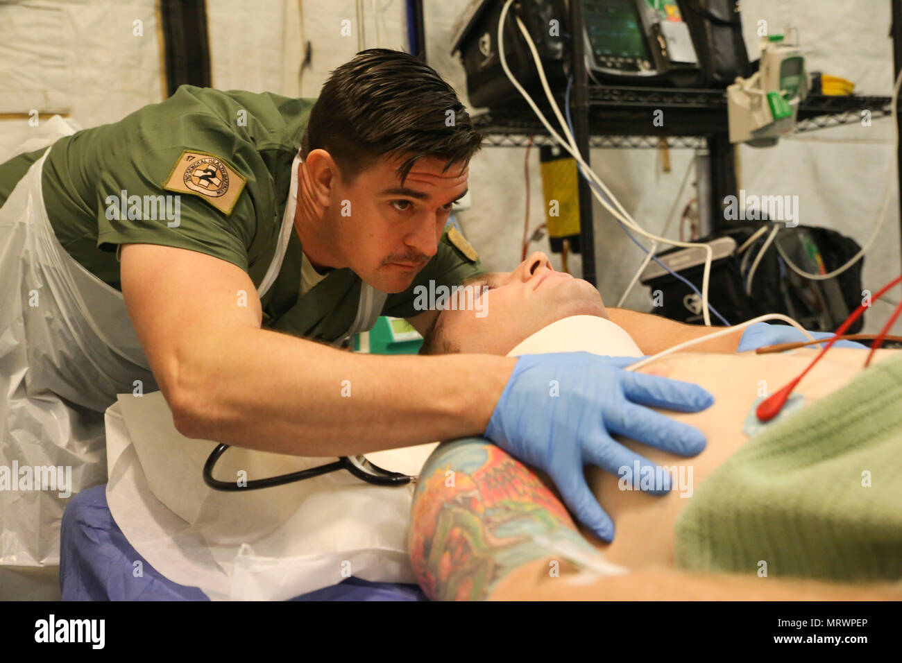 Corporal James Gummow, a medic with 2nd General Health Battalion, 17th Combat Service Support Brigade, evaluates a patient with a simulated sternum fracture during a mass casualty exercise at Williamson Air Field, Shoalwater Bay Training Area, Queensland, Australia, July 8, 2017 during Talisman Saber 17. Australian Army soldiers with 17th CSS Brigade conducted a mass-casualty exercise at Williamson Air Field hospital to practice Role 2 advanced trauma care and procedures that are used in a deployed environment. Exercises like Talisman Saber provide effective and intense training to ensure our  Stock Photo