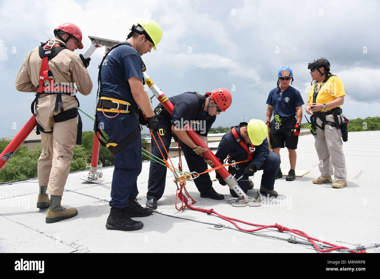 Members of the Keesler and Biloxi Fire Department, assemble a tripod atop  of the Weather Training Complex during rope rescue operations training June  14, 2017, on Keesler Air Force Base, Miss. Keesler