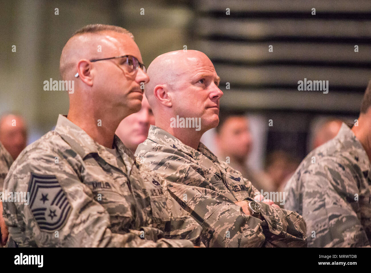 U.S. Air Force Chief Master Sgt. Randy Miller (left), command chief master sergeant of the 139th Airlift Wing (139th AW), Missouri Air National Guard, and Col. Ed Black, commander of the 139th AW listen as Lt. Gen. Scott Rice, director of the Air National Guard, and Chief Master Sgt. Ronald Anderson, command chief master sergeant of the Air National Guard, address Airmen at the St. Joseph Civic Arena, St. Joseph, Mo., July 8, 2017. Lt. Gen. Rice and Chief Master Sgt. Anderson, were in the process of visiting units across Missouri. While in St. Joseph, they toured Rosecrans Air National Guard B Stock Photo
