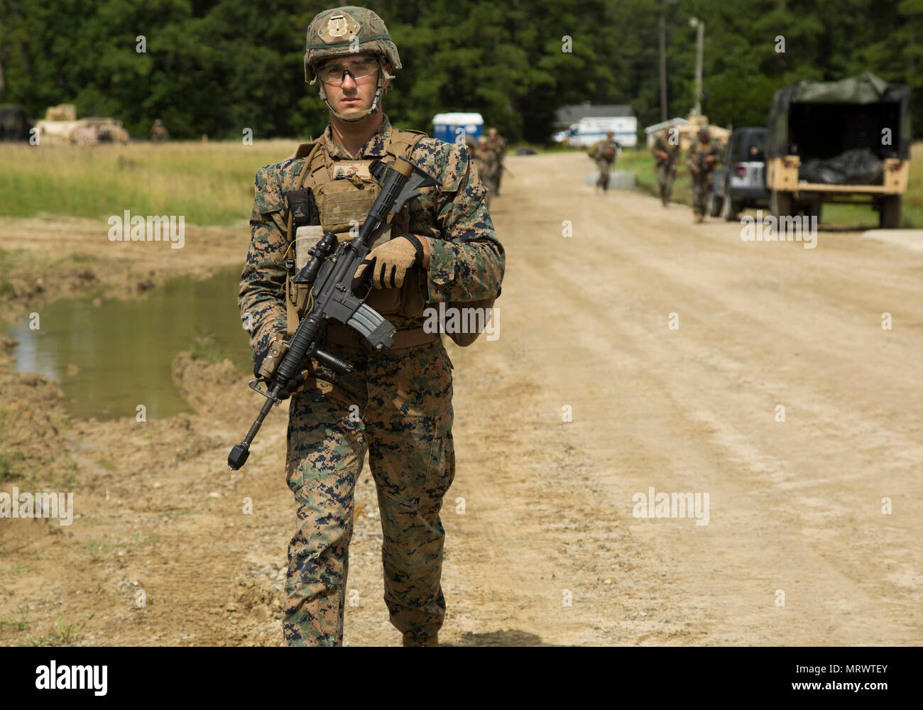 U.S. Marine Corps Cpl. Mitchell Brinkman, rifleman, with Alpha Company, 1st Battalion, 8th Marine Regiment, (1/8) 2nd Marine Division (2nd MARDIV) patrols during the Marine Corps Combat Readiness Evaluation (MCCRE), on Camp Lejeune, N.C., June 21, 2017. MCCRE was conducted to enhance and promote unit readiness for upcoming deployments. (U.S. Marine Corps photo by Cpl. John A. Hamilton Jr) Stock Photo