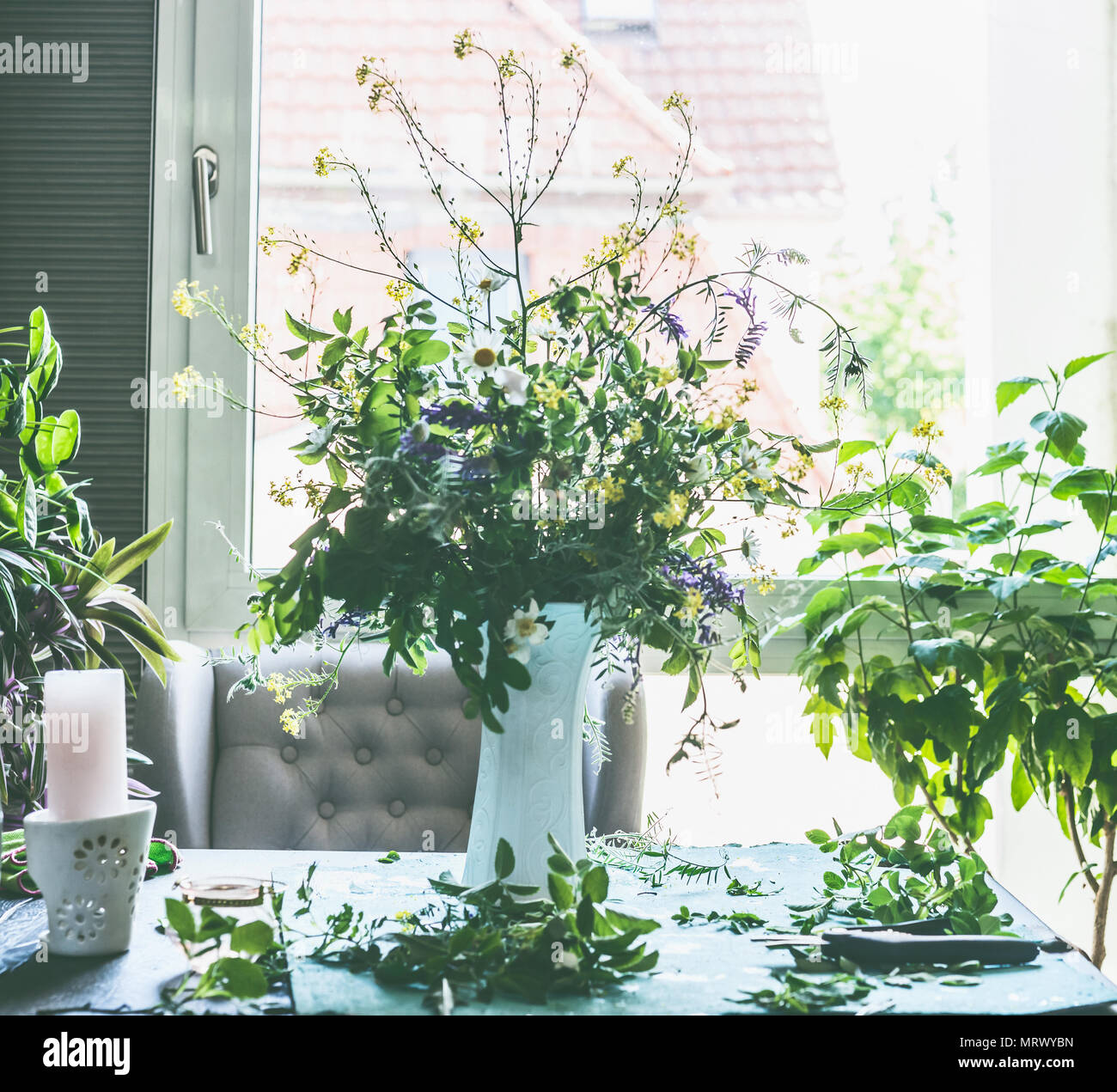Great summer wild flowers bunch in white vase on table in living Great summer wild flowers bunch in white vase on table in living