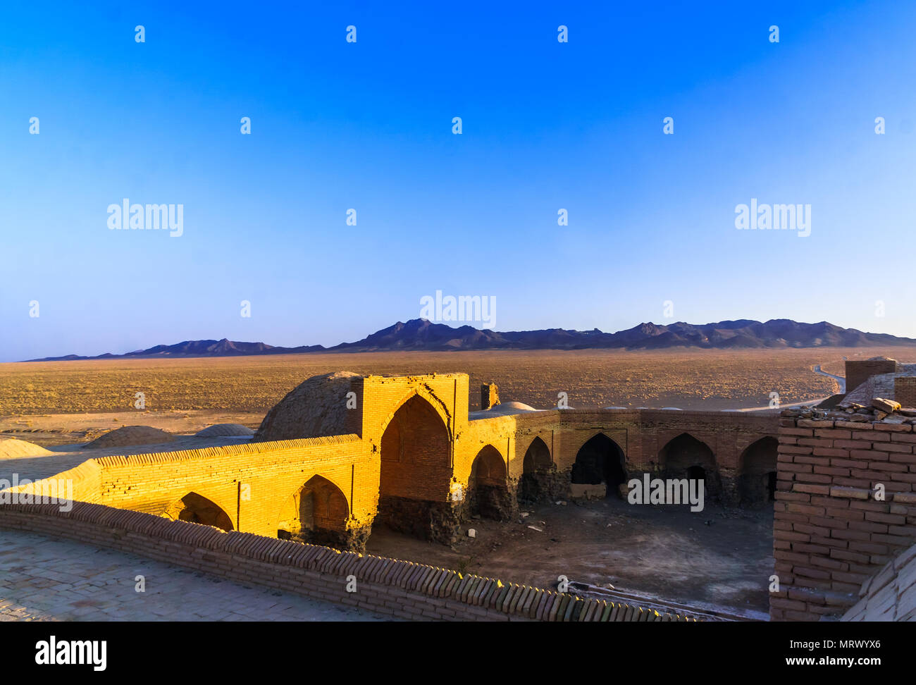 View on abonded caravansarai in the desert by Varzaneh - Iran Stock Photo