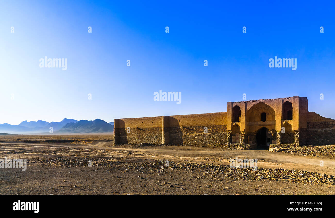 View on abonded caravansarai in the desert by Varzaneh - Iran Stock Photo
