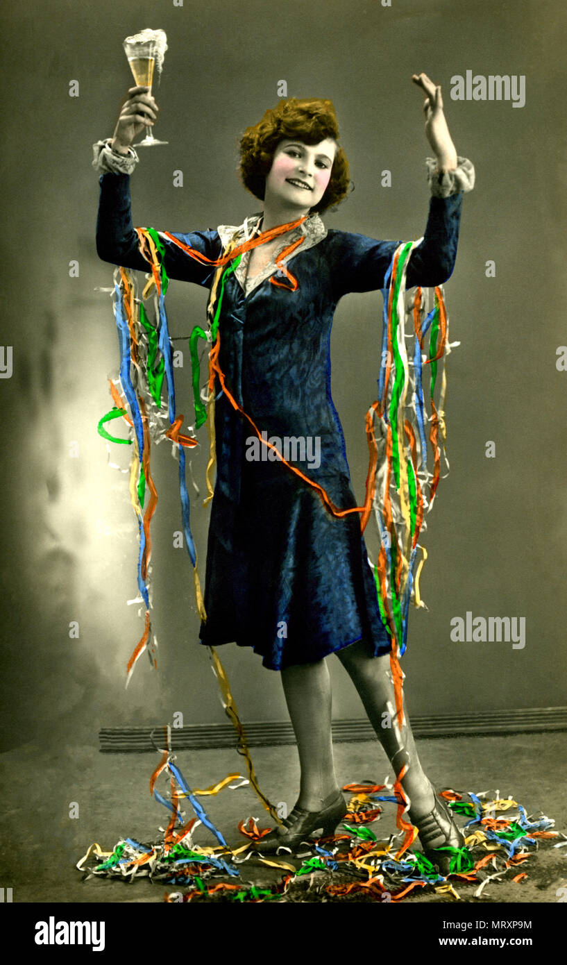 Woman celebrates New Year's Eve with champagne and paper snakes, 1920s,  Germany Stock Photo