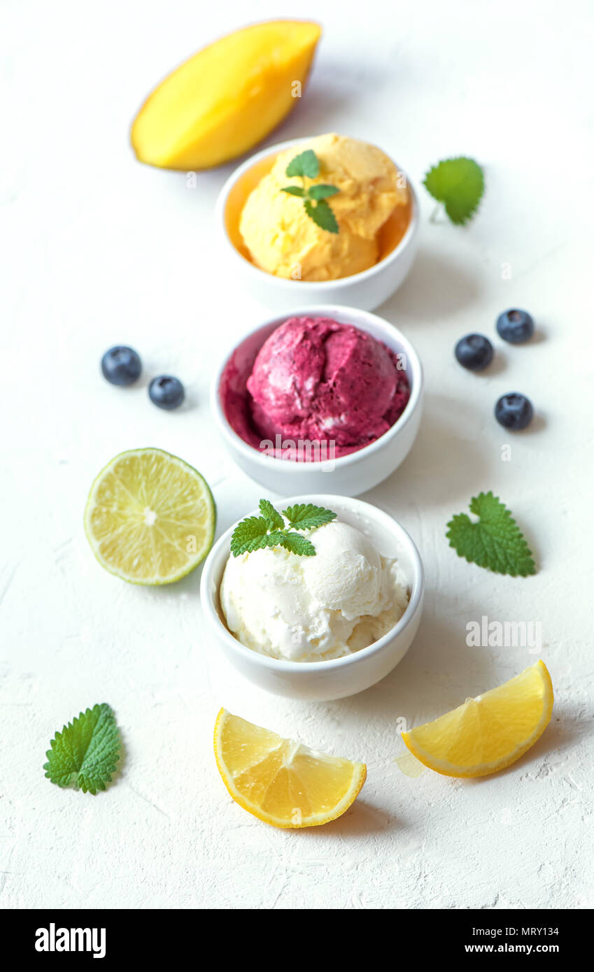 Three various fruit and berries ice creams on white background, copy