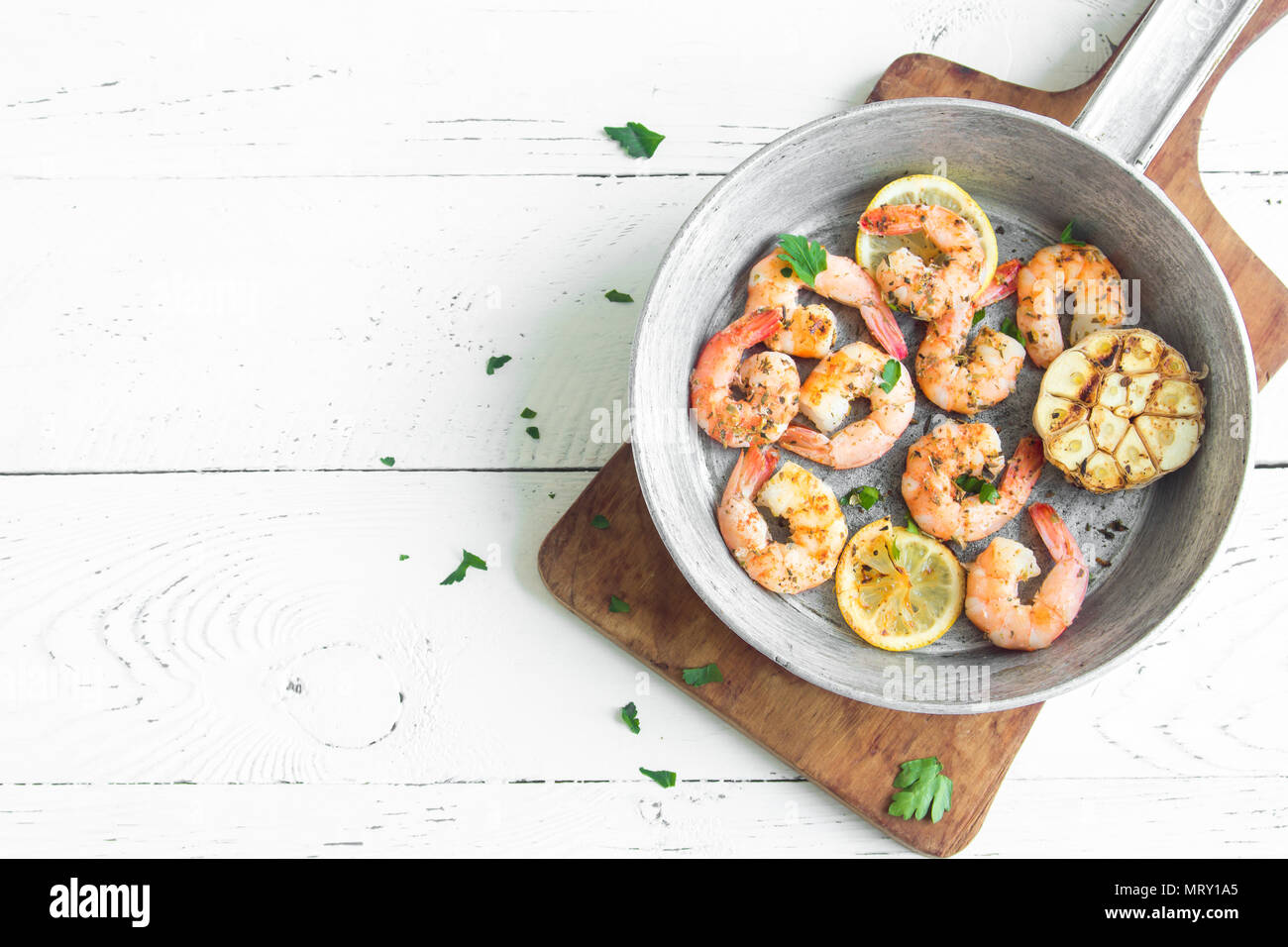 Roasted shrimps with lemon, garlic and herbs. Seafood, shelfish. Shrimps Prawns grilled with