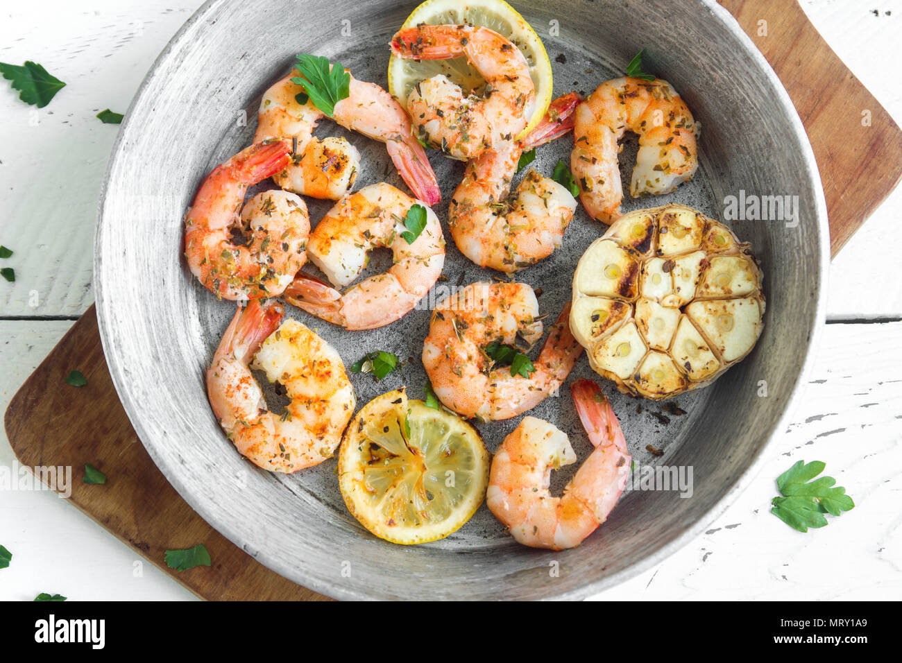 Roasted shrimps with lemon, garlic and herbs. Seafood, shelfish