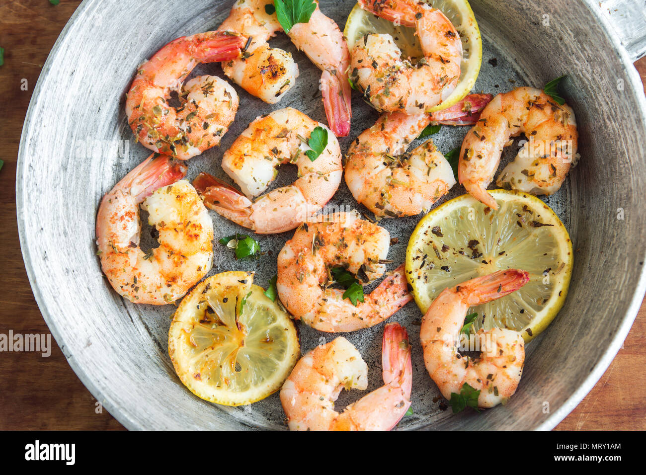 Roasted shrimps with lemon, garlic and herbs. Seafood, shelfish. Shrimps Prawns grilled with