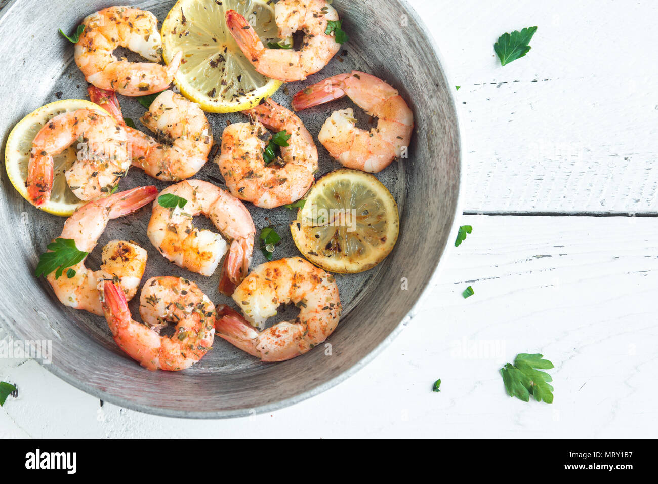 Roasted shrimps with lemon, garlic and herbs. Seafood, shelfish. Shrimps Prawns grilled with