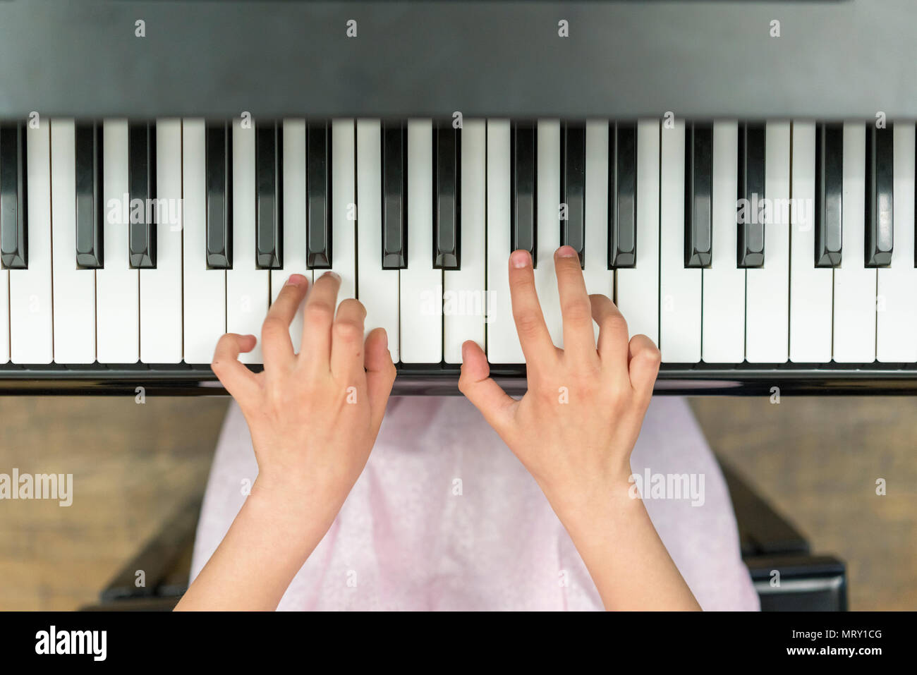 Hands on piano keys close-up. Closeup girl's hand playing piano. Favorite  classical music. Top view with dark vignette. View from above Stock Photo -  Alamy