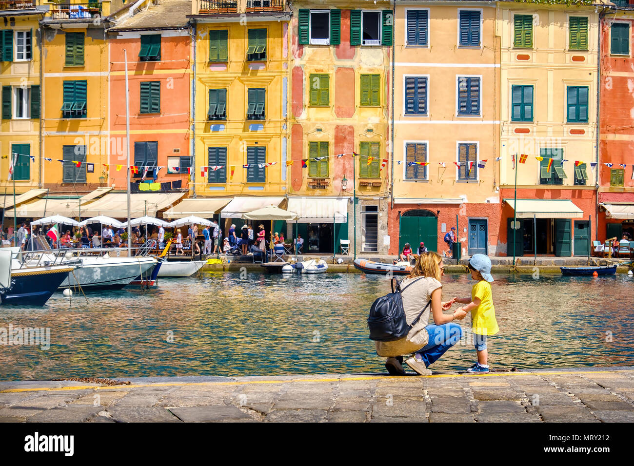 baby traveler travel with kids in Italy family trip mom and baby in Portofino Stock Photo