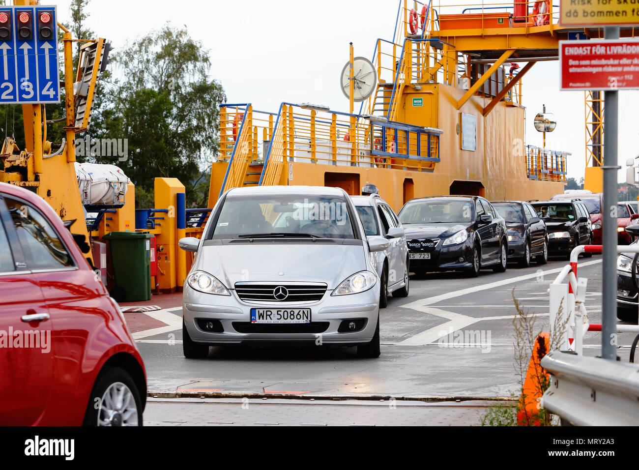 Slagsta, Sweden - August 13, 2014: Yellow road ferry with cars operated by the Swedish Transport Administration (Trafikverket) at the Slagsta berth wi Stock Photo