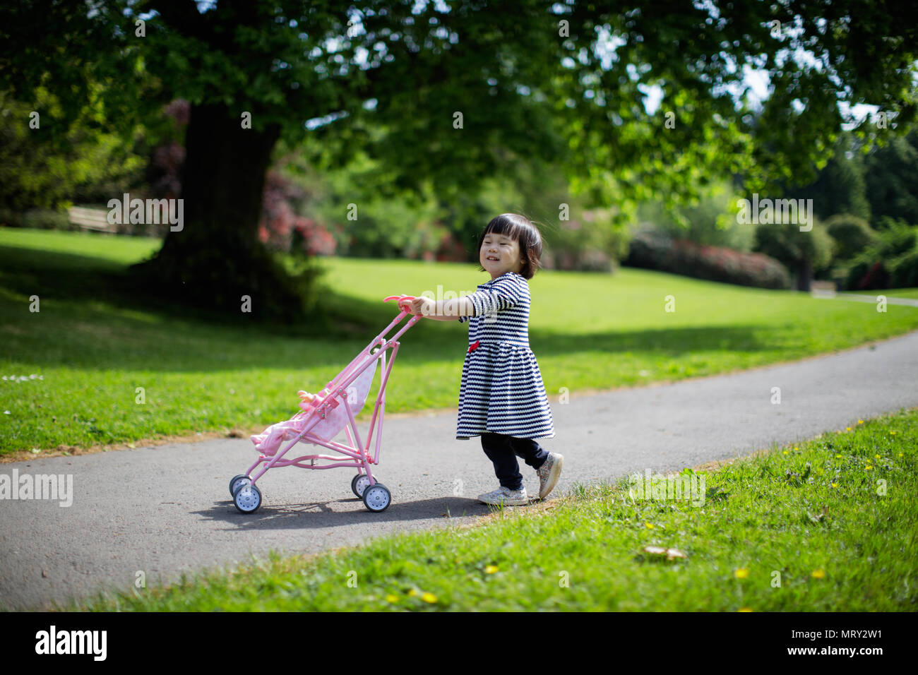 baby girl play at spring forest park Stock Photo - Alamy