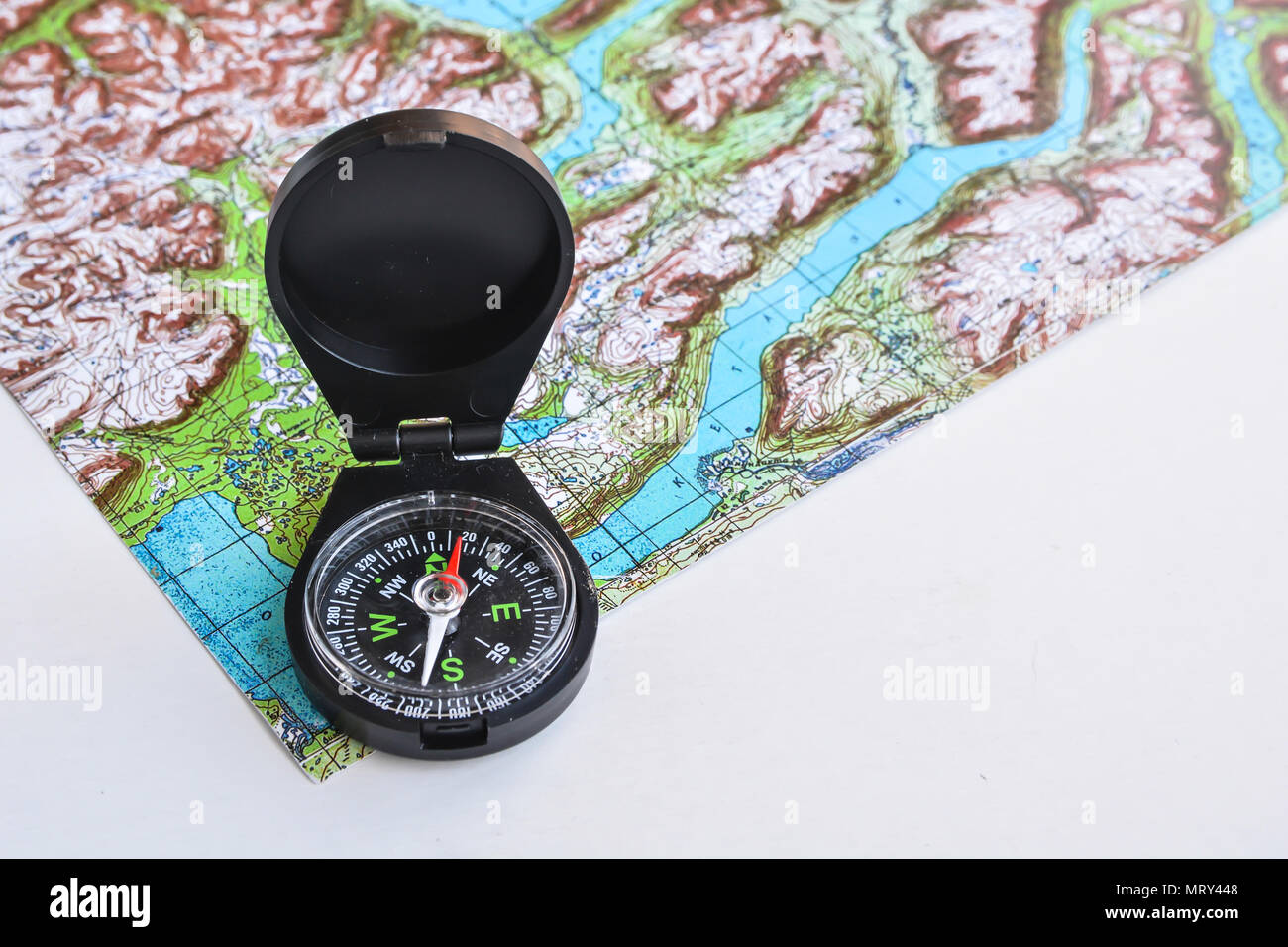 Compass and topographic map. Accessories travel so as not to get lost in the way. Stock Photo