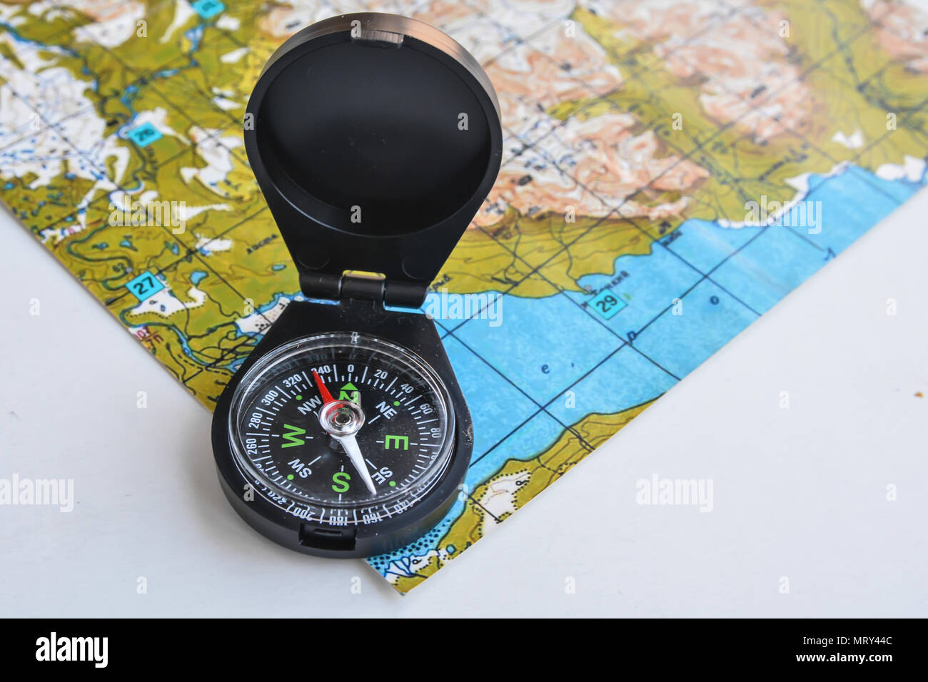 Compass and topographic map. Accessories travel so as not to get lost in the way. Stock Photo