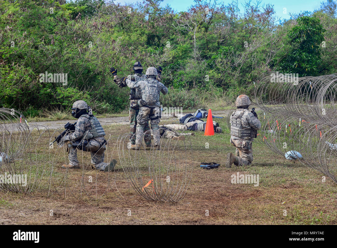 U.S. Air Force Airmen from the 644th Combat Communications Squadron captures an Airman acting as an opposing force during exercise Dragon Forge June 15, 2017, at Andersen South, Guam. Opposing forces repeatedly attacked the base throughout the day prior to an all-out final attack from all sides with the goal of overrunning the base. (U.S. Air Force photo by Airman 1st Class Christopher Quail) Stock Photo