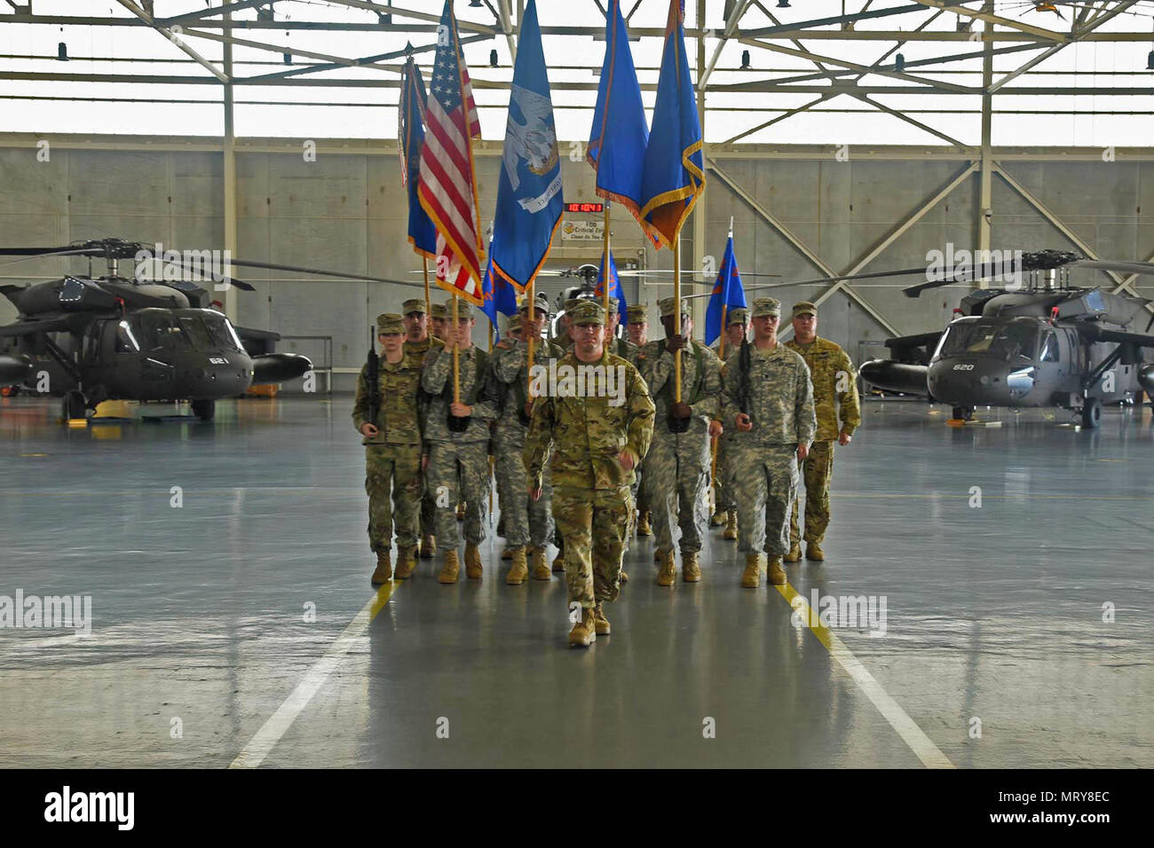 Louisiana National Guardsman Maj. Jacques Comeaux leads the State Aviation Command colors forward during an official change of command and promotion ceremony at Army Aviation Facility #1 in Hammond, Louisiana, July 9, 2017. During the ceremony, Brig. Gen. Patrick Bossetta was pinned with the one-star rank after relinquishing command of the State Aviation Command to Col. John Plunkett and command of the 204th Theater Airfield Operations Group to Lt. Col. John Bonnette. (U.S. Army National Guard photo by Sgt. Garrett L. Dipuma) Stock Photo