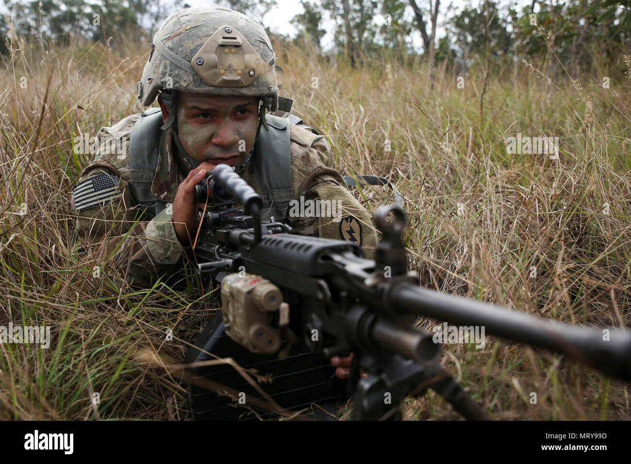 U.S. Army Pfc. Christopher Ocasio, combat engineer with A Company, 6th Brigade Engineer Battalion, provides security at a rally point after parachuting out of a C-17 Globemaster July 13, 2017 at Drop Zone Kapyong, Williamson Airfield, Shoalwater Bay Training Area, Queensland, Australia. Combined coalition forces from the United States and Canadian militaries conducted a small-scale tactical operation during Talisman Saber 17. Exercises like Talisman Saber provide effective and intense training to ensure our forces are capable, interoperable, deployable on short notice and combat-ready. (U.S. M Stock Photo