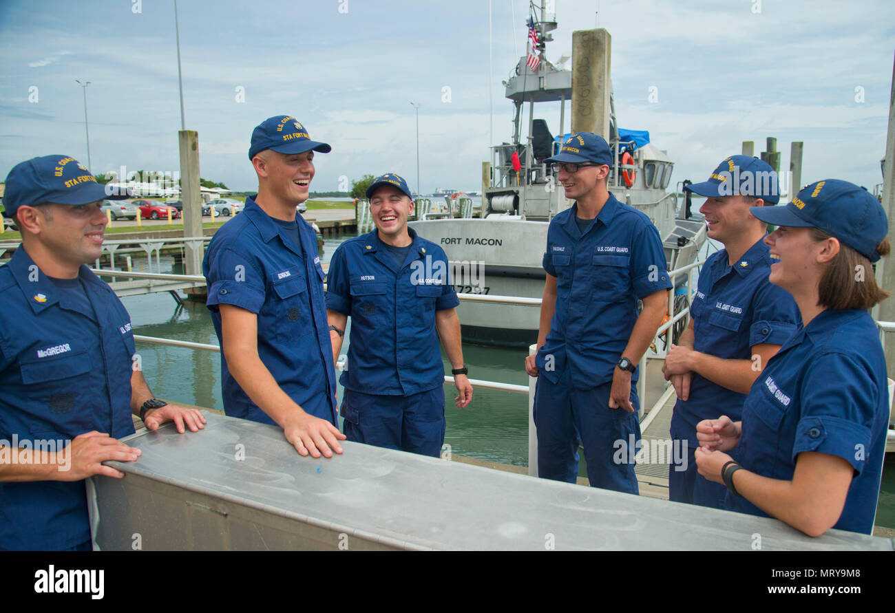 Petty Officer 2nd Class Tyler McGregor (left to right), Seaman Crewe Goralski, Petty Officer 2nd Class Zane Hutson, Fireman Samuel Ragsdale, Petty Officer 3rd Class Michael Sparks and Fireman Jordan Markland, Coast Guardsmen at Station Fort Macon, recall a recent rescue at the station, July 10, 2017. Sparks and Ragsdale were rescued by the others after a diving trip gone wrong a few days earlier. (U.S. Coast Guard photo by Petty Officer 2nd Class Nate Littlejoh/Released) Stock Photo