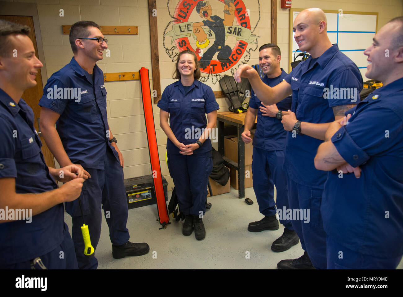 Petty Officer 3rd Class Michael Sparks (left to right), Fireman Samuel Ragsdale, Fireman Jordan Markland, Petty Officer 2nd Class Tyler McGregor, Seaman Crewe Goralski and Petty Officer 2nd Class Zane Hutson reunite at Station Fort Macon, North Carolina, July 10, 2017. Sparks and Ragsdale were rescued by the others July 6 after a diving incident where the two were stranded and clung to the orange safety sausage (seen center) to stay together. (U.S. Coast Guard photo by Petty Officer 2nd Class Nate Littlejohn) Stock Photo