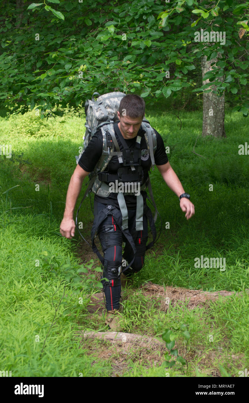 A Soldier wears an exosuit while on a three-mile outdoor course at a U.S. Army Research Laboratory facility at Aberdeen Proving Ground, Maryland. The suit, which is part of the Army's Warrior Web Program has pulleys and gears designed to prevent and reduce musculoskeletal injuries caused by dynamic events typically found in the warfighter's environment. (Photo Credit: U.S. Army photo by Rob Carty) Stock Photo