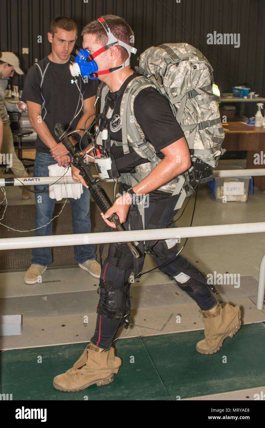 A Soldier wears an exosuit while on a treadmill at a U.S. Army Research Laboratory facility at Aberdeen Proving Ground, Maryland. The suit, which is part of the Army's Warrior Web Program has pulleys and gears designed to prevent and reduce musculoskeletal injuries caused by dynamic events typically found in the warfighter's environment. Researchers use the feedback gained for ongoing research and developments as they continue to refine the prototypes. (Photo Credit: U.S. Army photo by Ron Carty) Stock Photo