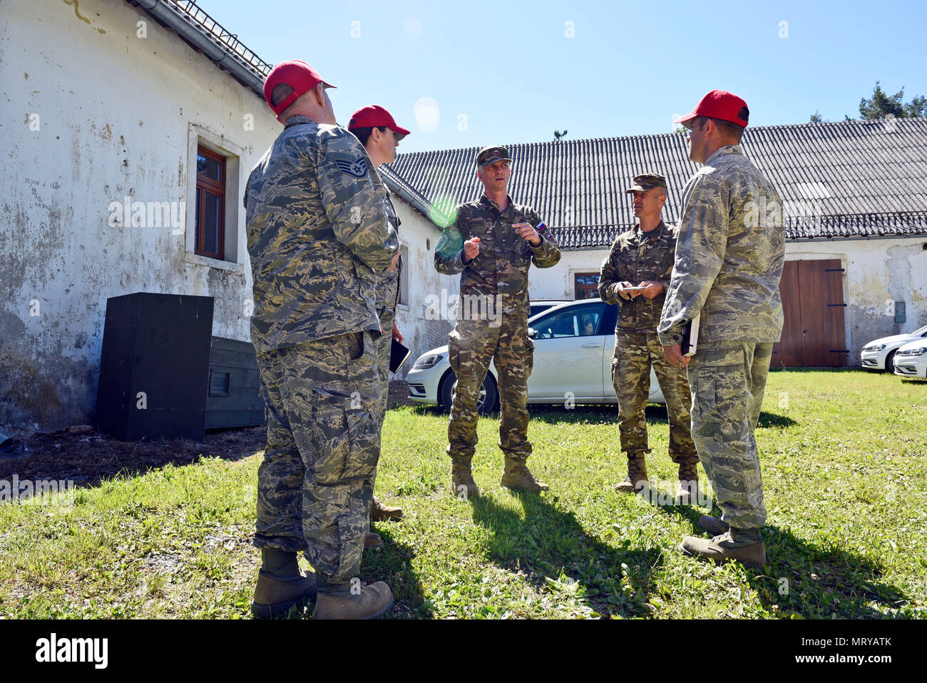 219th RED HORSE Squadron personnel and Slovenian Armed Forces members meet  to discuss progress and needs at the Bile barn site Pocek base, near  Postonja, Slovenia June 9, 2017. The 219th RHS
