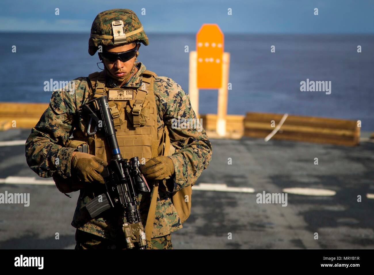 U.S. Marine Corps Lance Cpl. Daniel Fuller, an infantryman with Task Force Koa Moana 17, walks up range after analyzing his shot group during a live fire range aboard the USNS Sacagawea, July 13, 2017. Koa Moana 17 is designed to improve interoperability with our partners, enhance military-to-military relations, and expose the Marine Corps forces to different types of terrain for familiarity in the event of a natural disaster in the region.   (U.S. Marine Corps photo by MCIPAC Combat Camera Lance Cpl. Juan C. Bustos) Stock Photo