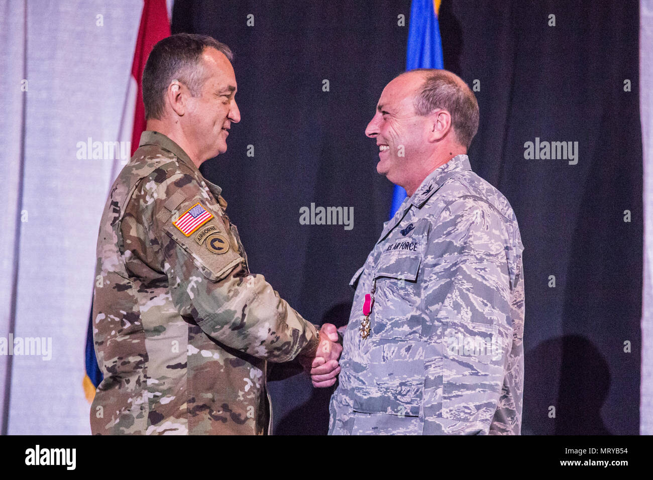 U.S. Army Maj. Gen. Stephen Danner, adjutant general of the Missouri National Guard, presents the Legion of Merit, to Col. Ralph Schwader, commander of the 139th Airlift Wing, Missouri Air National Guard, during a change of command ceremony at the St. Joseph Civic Arena, St. Joseph, Mo., July 8, 2017. Col. Ed Black took command of the 139th AW, from Col. Schwader. Col. Schwader will be assigned to Missouri Air National Guard Headquarters in Jefferson City, after more than 3 years commanding the 139th. (U.S. Air National Guard photo by Staff Sgt. Patrick P. Evenson) Stock Photo