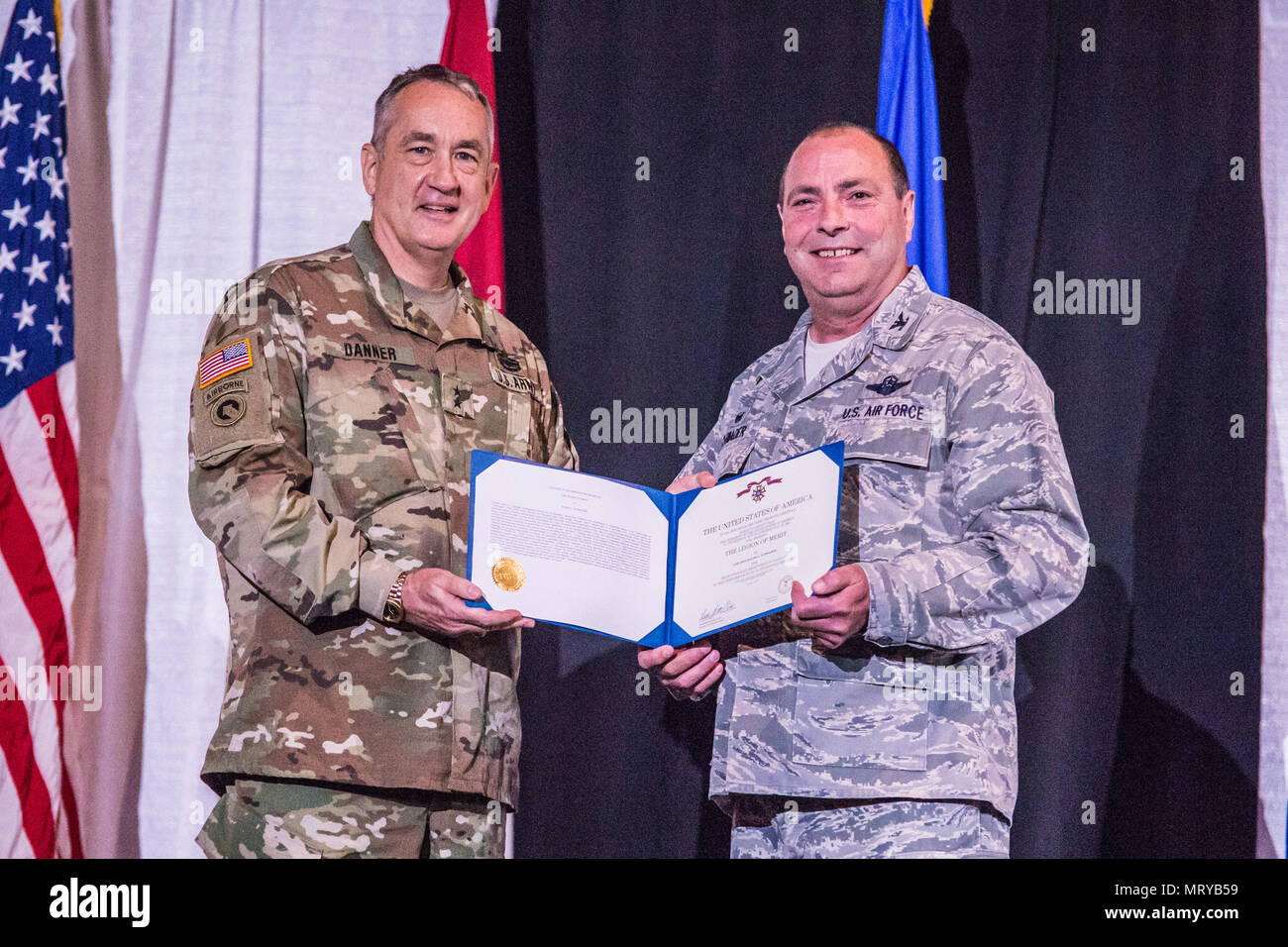 U.S. Army Maj. Gen. Stephen Danner, adjutant general of the Missouri National Guard, presents the Legion of Merit, to Col. Ralph Schwader, commander of the 139th Airlift Wing, Missouri Air National Guard, during a change of command ceremony at the St. Joseph Civic Arena, St. Joseph, Mo., July 8, 2017. Col. Ed Black took command of the 139th AW, from Col. Schwader. Col. Schwader will be assigned to Missouri Air National Guard Headquarters in Jefferson City, after more than 3 years commanding the 139th. (U.S. Air National Guard photo by Staff Sgt. Patrick P. Evenson) Stock Photo