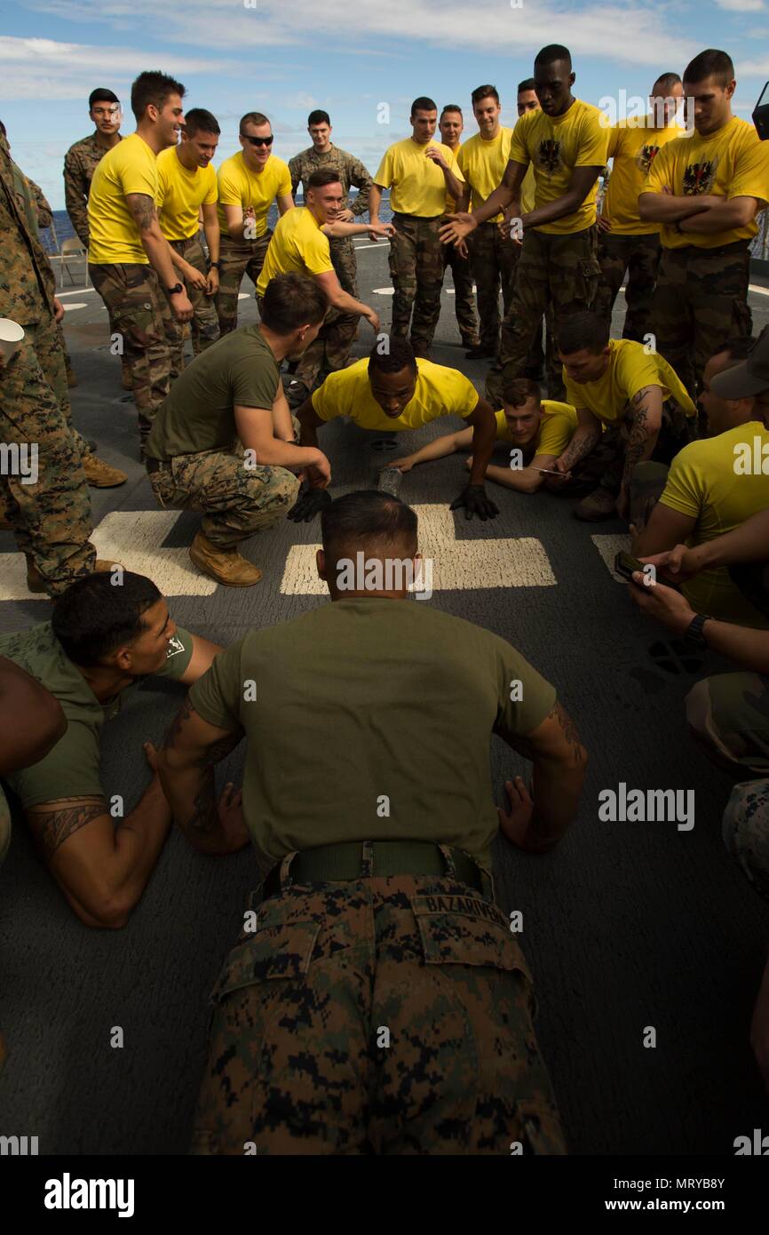 USNS SACAGAWEA— Lance Cpl. Austin Bazarivera competes in a pushup contest against French soldiers in celebration of Bastille Day July 14 aboard the USNS SACAGAWEA. Bastille Day is recognized as the day the French gained their independence from King Louis XVI by liberating prisoners from the Bastille Prison in 1789 and are now celebrating their 228th year as a free nation. Bazarivera is a machine gunner with 3rd Battalion, 4th Marine Regiment, currently deployed to Koa Moana 17. (U.S. Marine Corps Photo by Sgt. Douglas D. Simons) Stock Photo