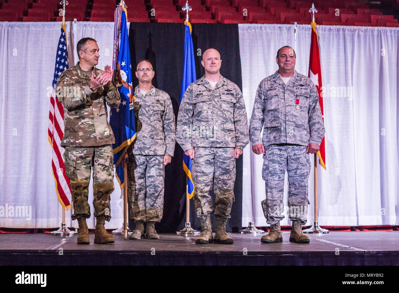 U.S. Air Force Col. Ed Black (center) takes command of the 139th Airlift Wing, Missouri Air National Guard, from Col. Ralph Schwader (right), during a change of command ceremony at the St. Joseph Civic Arena, St. Joseph, Mo. July 8, 2017. Col. Schwader will be assigned to Missouri Air National Guard Headquarters in Jefferson City, after more than 3 years commanding the 139th. (U.S. Air National Guard photo by Staff Sgt. Patrick P. Evenson) Stock Photo