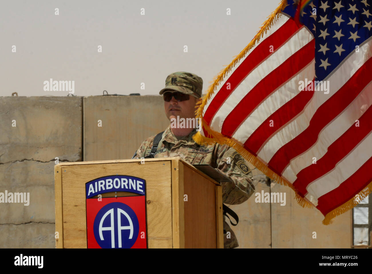 U.S. Army Capt. Scott Rayburn, commander of Alpha Company, 37th Engineer Battalion, 2nd Brigade Combat Team, 82nd Airborne Division, addresses those in attendance, especially his sister, U.S. Army Capt. Kaitlin Whitmore, commander of Charlie Company, 215th Brigade Support Battalion, 3rd Armored Brigade Combat Team, 1st Cavalry Division, during his first-ever change-of-command ceremony at Qayyarah West Airfield, Iraq, July 1, 2017. (U.S. Army photo by Staff Sgt. Leah R. Kilpatrick) Stock Photo