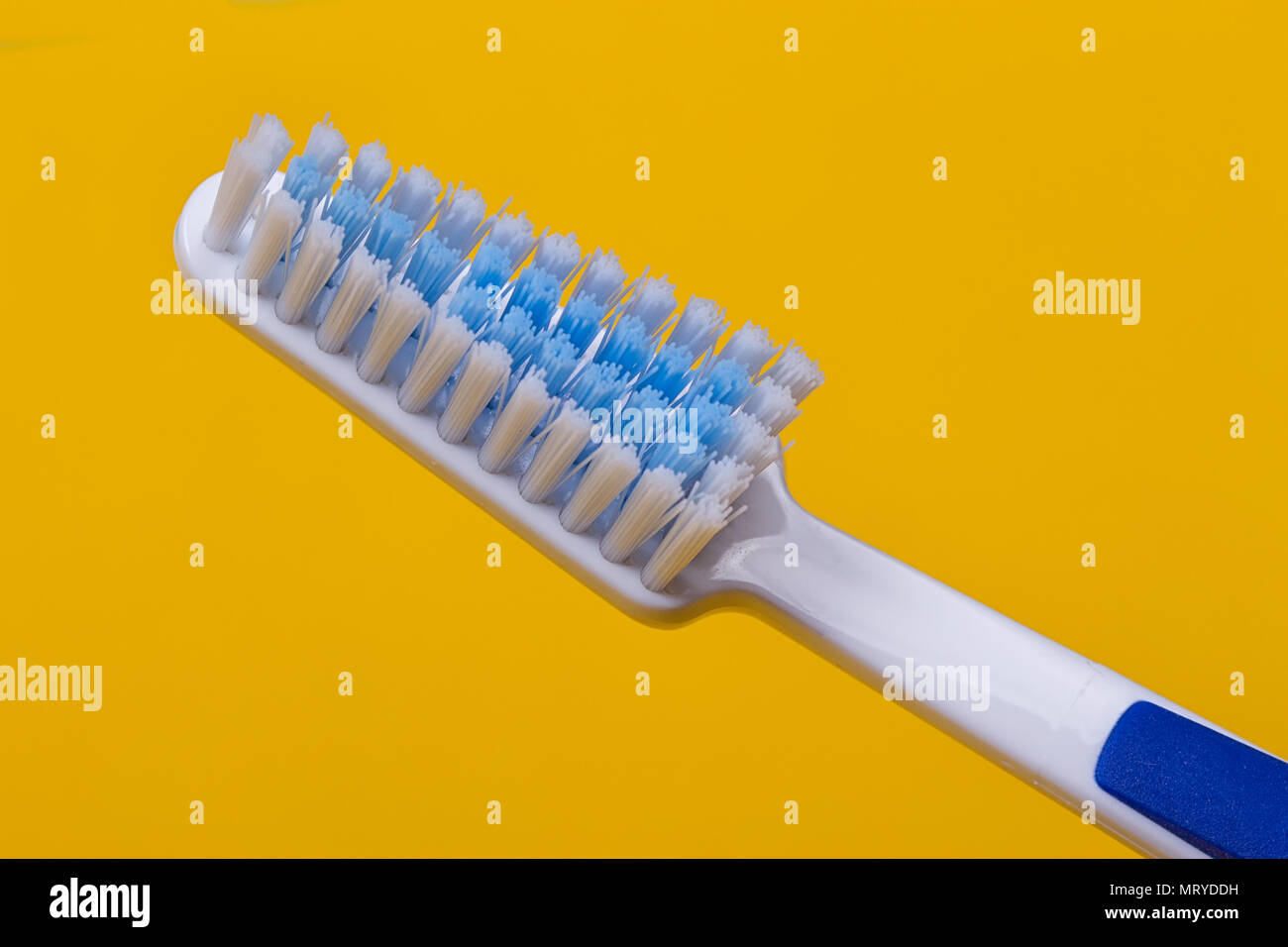 Toothbrushes on the yellow background. Top view Stock Photo - Alamy
