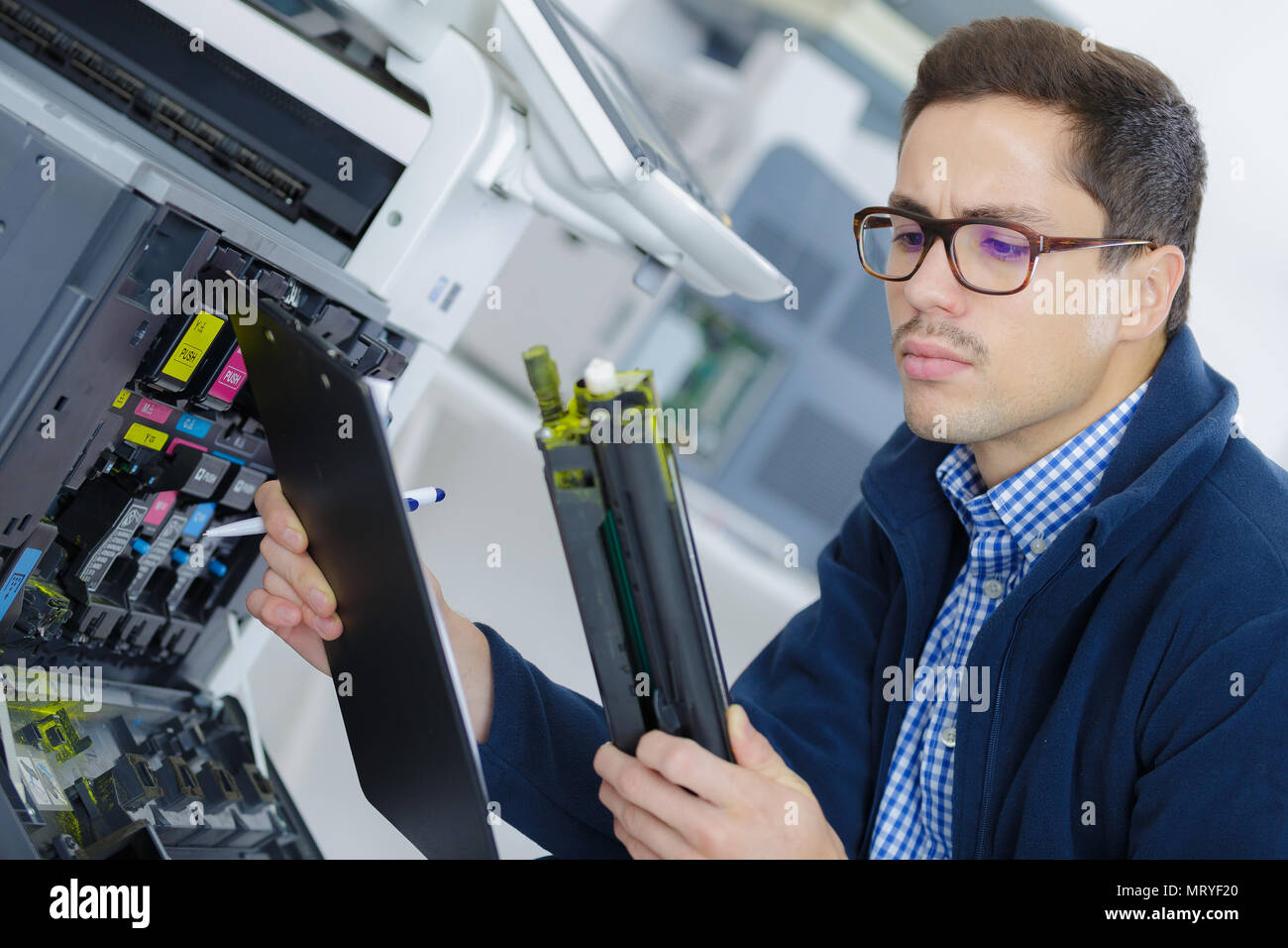 young engineer in the lab adjusting a 3d printers components Stock Photo