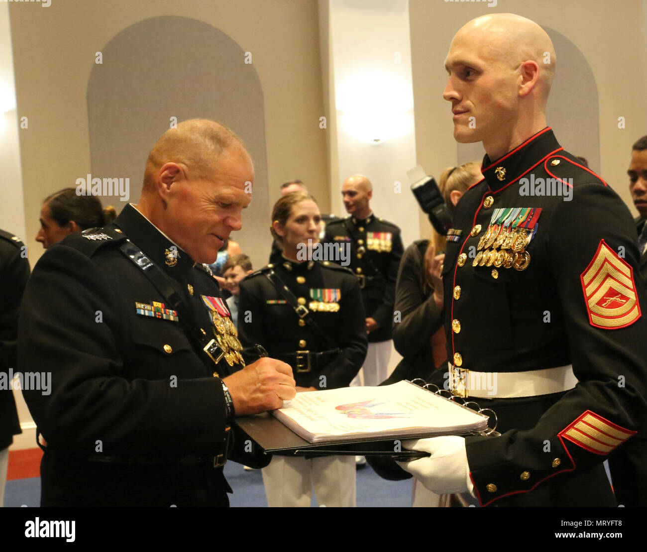The Commandant of the Marine Corps, Gen. Robert B. Neller, signs the ...