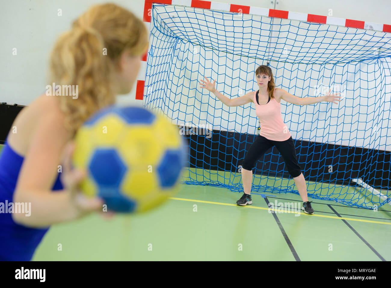 Woman playing handball, aiming for goal Stock Photo