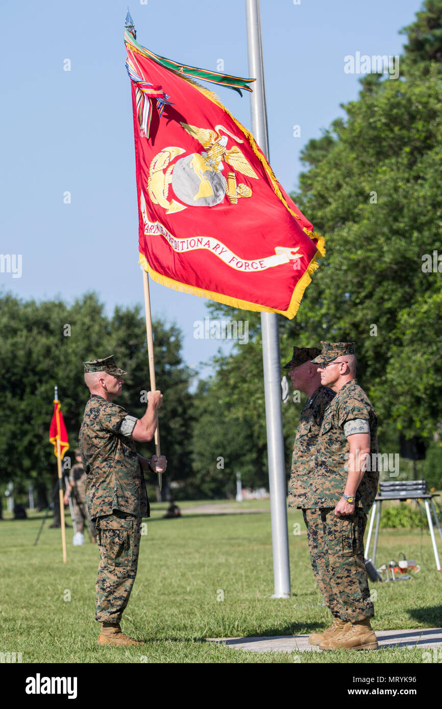 U.S. Marine Corps Sgt. Maj. Bryan Thresher, left, the II Marine Expeditionary Force (MEF) sergeant major, presents the unit colors to Maj. Gen. Walter L. Miller, commanding general of II MEF, during a change of command ceremony on Camp Lejeune, N.C., July 14, 2017. During the ceremony, Maj. Gen. Walter L. Miller Jr. relinquished his command as commanding general of II MEF to Lt. Gen. Robert F. Hedelund. (U.S. Marine Corps photo by Lance Cpl. Koby I. Saunders) Stock Photo