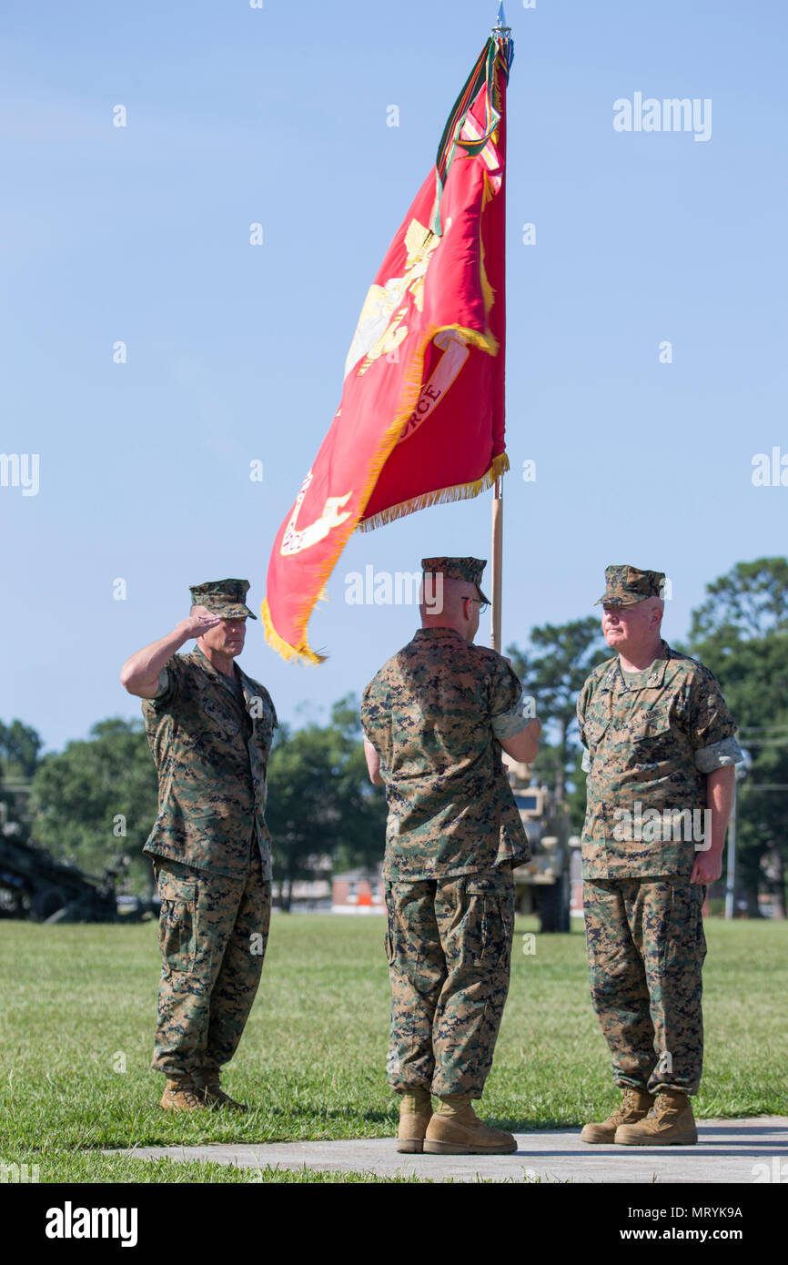 U.S. Marine Corps Sgt. Maj. Bryan Thresher, left, the II Marine Expeditionary Force (MEF) sergeant major, salutes as the current and former commanding generals of the II MEF pass the colors during a change of command ceremony on Camp Lejeune, N.C., July 14, 2017. During the ceremony, Maj. Gen. Walter L. Miller Jr. relinquished his command as commanding general of II MEF to Lt. Gen. Robert F. Hedelund. (U.S. Marine Corps photo by Lance Cpl. Koby I. Saunders) Stock Photo