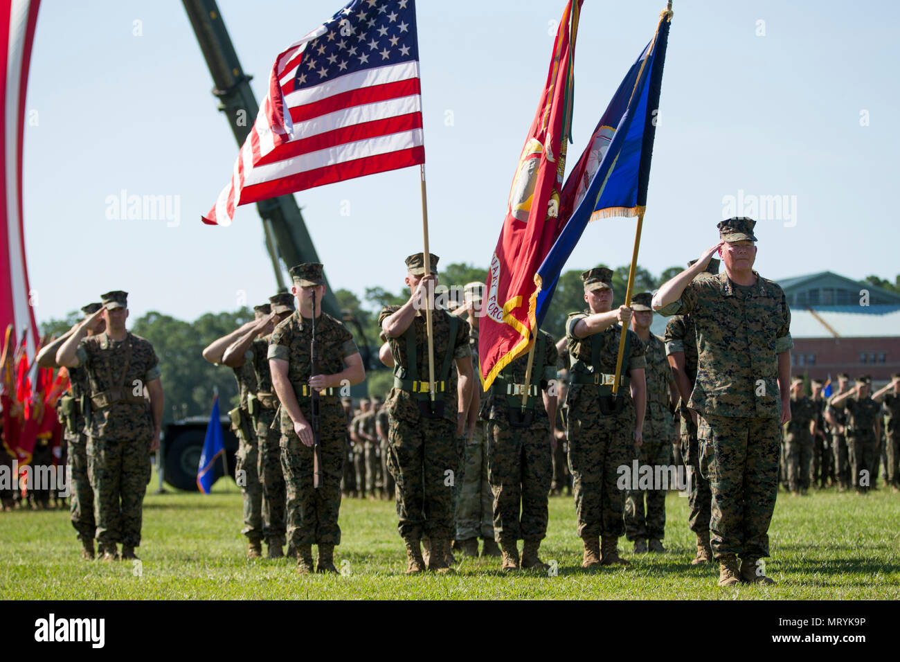 U.S. Marine Corps Maj. Gen. Walter L. Miller Jr., right, and Marines assigned to II Marine Expeditionary Force (MEF) salute during a change of command ceremony on Camp Lejeune, N.C., July 14, 2017. During the ceremony, Maj. Gen. Walter L. Miller Jr. relinquished his command as commanding general of II MEF to Lt. Gen. Robert F. Hedelund. (U.S. Marine Corps photo by Lance Cpl. Koby I. Saunders) Stock Photo