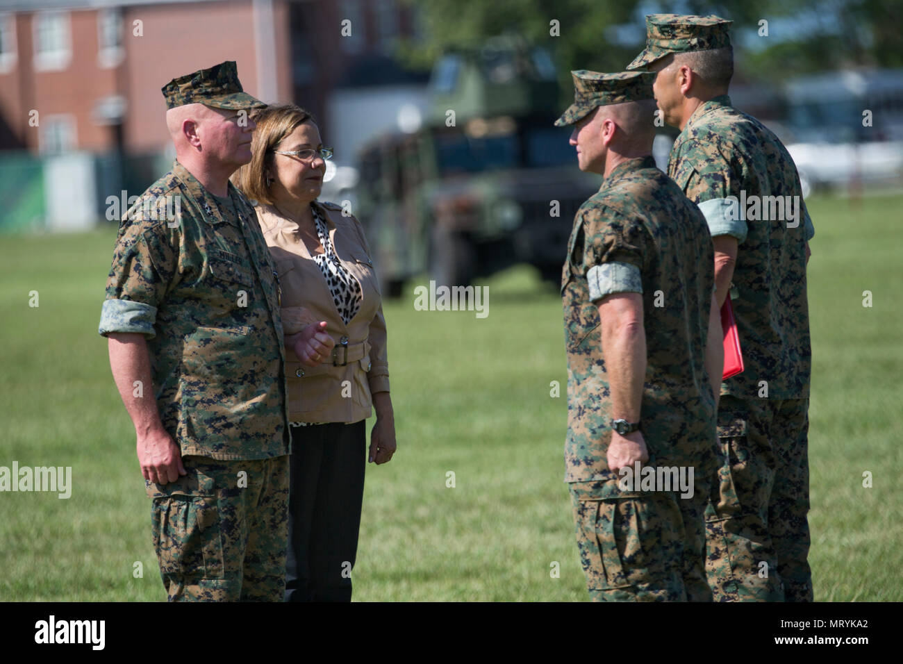 U.S. Marine Corps Maj. Gen. Walter L. Miller's wife, Mrs. Marcela Davila about to receive recognition from Lt. Gen. Michael G. Dana, deputy commandant for installations and logistics, during a change of command ceremony on Camp Lejeune, N.C., July 14, 2017. During the ceremony, Miller relinquished his command as commanding general of II MEF to Lt. Gen. Robert F. Hedelund. (U.S. Marine Corps photo by Lance Cpl. Koby I. Saunders) Stock Photo