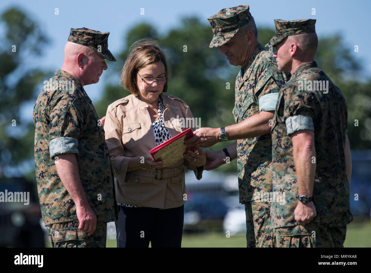 U.S. Marine Corps Maj. Gen. Walter L. Miller's wife, Mrs. Marcela Davila is awarded by Lt. Gen. Michael G. Dana, deputy commandant for installations and logistics, during a change of command ceremony on Camp Lejeune, N.C., July 14, 2017. During the ceremony, Miller relinquished his command as commanding general of II MEF to Lt. Gen. Robert F. Hedelund. (U.S. Marine Corps photo by Lance Cpl. Koby I. Saunders) Stock Photo