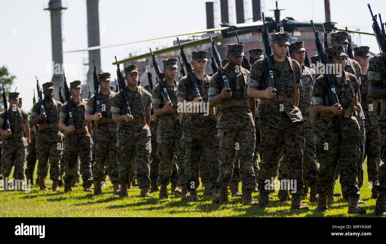 U.S. Marines assigned to the II Marine Expeditionary Force (MEF) march during a pass and review while conducting a change of command ceremony on Camp Lejeune, N.C., July 14, 2017. During the ceremony, Maj. Gen. Walter L. Miller Jr. relinquished his command as commanding general of II MEF to Lt. Gen. Robert F. Hedelund. (U.S. Marine Corps photo by Lance Cpl. Koby I. Saunders) Stock Photo