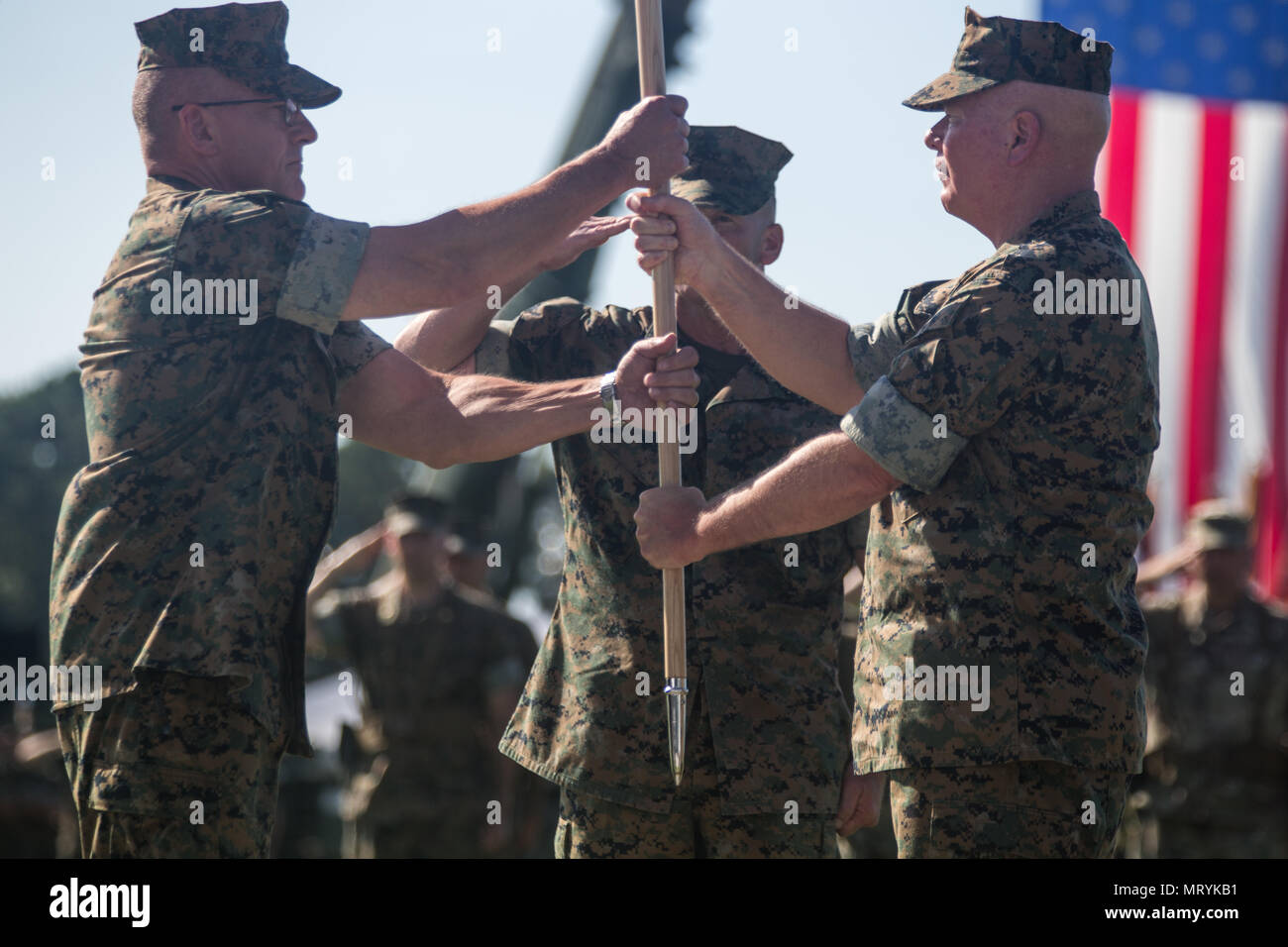 U.S. Marine Corps Maj. Gen. Walter L. Miller, Jr., right, passes the II Marine Expeditionary Force (II MEF) colors to Lt. Gen. Robert F. Hedelund, left, during the II MEF change of command ceremony on Camp Lejeune, N.C., July 14, 2017. During the ceremony, Miller relinquished his post as commanding general of II MEF to Hedelund. (U.S. Marine Corps photo by Lance Cpl. Zachary M. Ford) Stock Photo