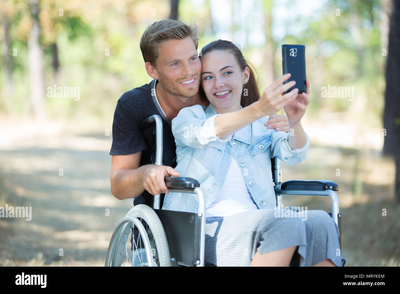 young girl on wheelchair taking a selfie with boyfriend Stock Photo - Alamy