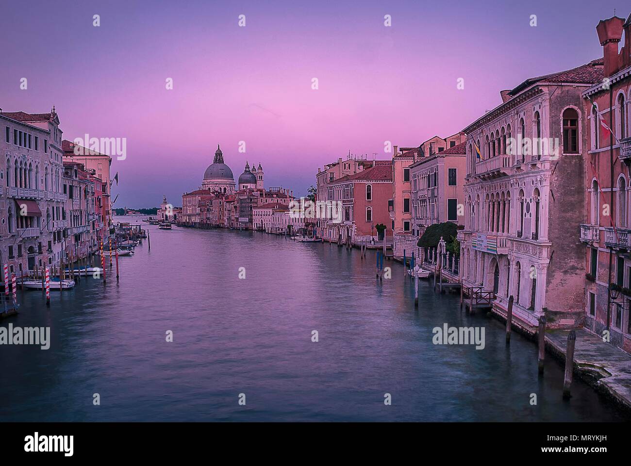The sun sets over the Basilica and Grand Canal in Venice, Italy Stock ...