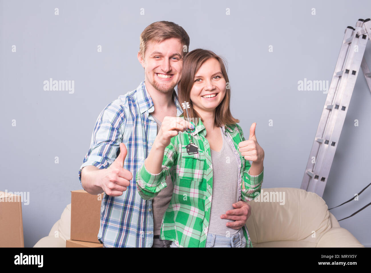 Happy love couple in her new home holding key Stock Photo - Alamy