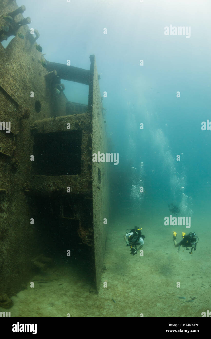 Two scuba divers explore the C-59 shipwreck underwater near La Paz, Mexico. Stock Photo