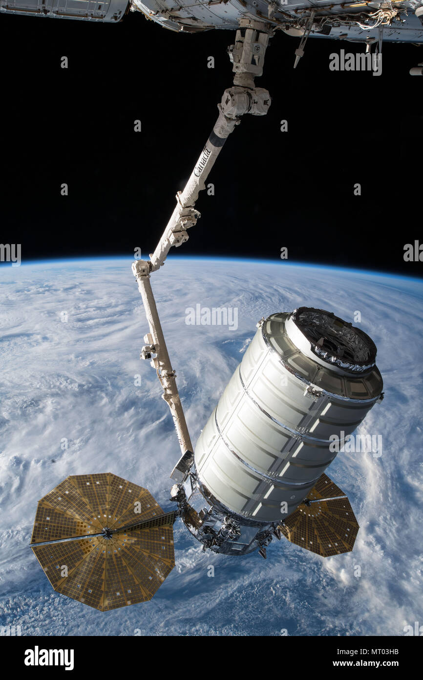 The Orbital ATK Cygnus cargo spacecraft is grabbled by the Canada Arm 2 for docking with the International Space Station May 24, 2018 in Earth Orbit. Stock Photo